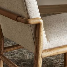 a close up of a wooden chair on a rug