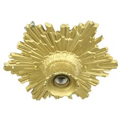 a gold plated metal object on a white background