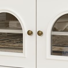 two white doors with gold handles on each side