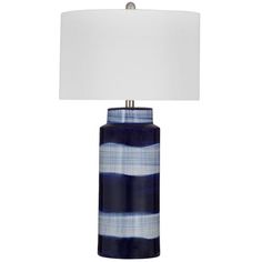 a blue and white striped lamp with a white shade on it's base, against a white background