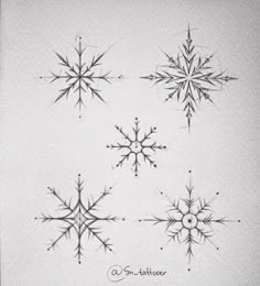 four snowflakes are shown in black and white ink on a piece of paper