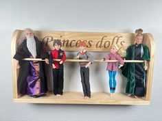 a group of dolls standing in front of a wooden sign that says princess golfs