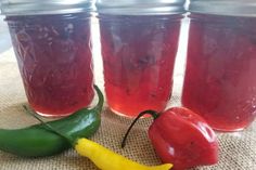 three jars filled with pickles and peppers