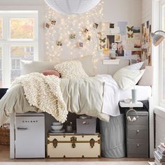 a bedroom with white walls and lots of pictures on the wall, including a bed