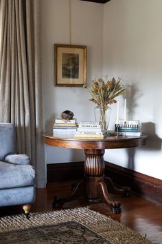 a living room with a couch, table and books