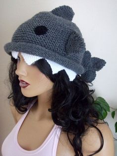 a woman wearing a knitted hat with a shark on it