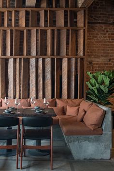 a living room filled with lots of furniture next to a wall covered in wooden planks