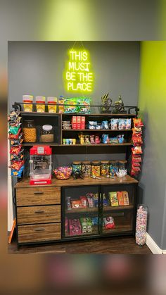 the inside of a grocery store with shelves and bins full of food, including snacks