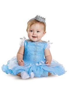 a baby girl wearing a blue dress and a tiara