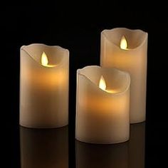 three lit candles sitting next to each other