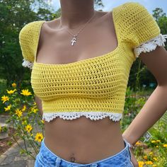 a close up of a woman wearing a yellow crop top