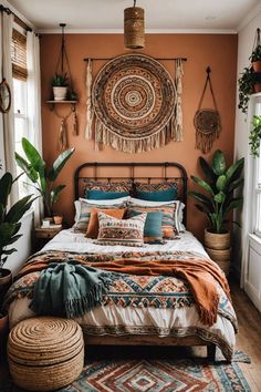 a bedroom with an orange wall and lots of plants in the corner, along with a bed