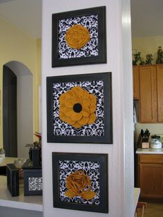 three black and white pictures hanging on the wall with yellow flowers in each one frame