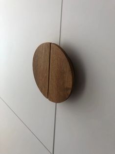 a round wooden object mounted on the side of a wall