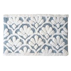 a blue and white rug with an intricate design on the front, featuring hearts in different sizes