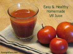 three tomatoes sitting on top of a cloth next to a glass of tomato juice with the words easy & healthy homemade v8 juice