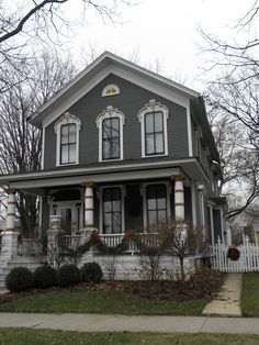 a gray house with white trim and windows