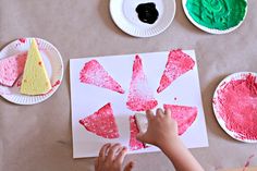 a child is making paper plates with food on them