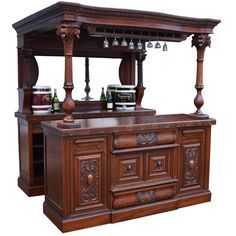 an old fashioned wooden bar with wine glasses on the top and two shelves above it