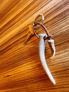 a wooden table with a keychain and two deer antler heads on it