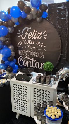 there is a table with balloons and desserts on it at a party in the shape of a circle