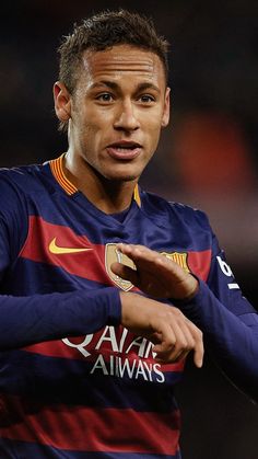 a soccer player is holding his hand out and looking at the camera with an intense look on his face