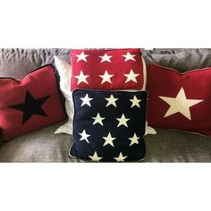 three red, white and blue pillows with stars on them are sitting on a couch