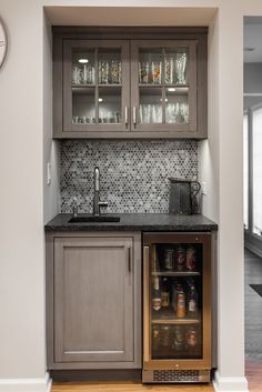 a small kitchen with an ice chest and built - in beverage dispenser