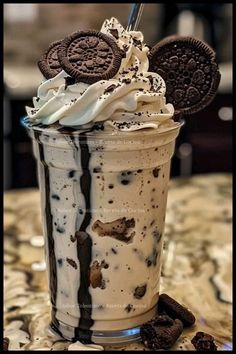 an ice cream sundae with oreo cookies and milkshake on the top