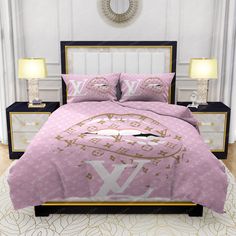 a bed with pink comforter and pillows on top of it in a white room