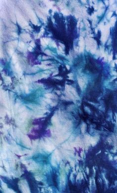 blue and purple tie dyed fabric with flowers on it