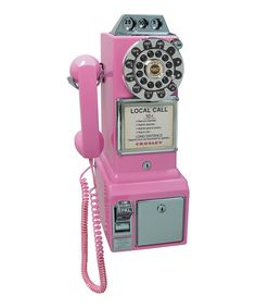 an old fashioned pink rotary telephone