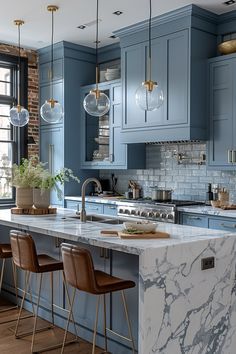 a kitchen with blue cabinets and marble counter tops, along with bar stools that match the hardwood flooring