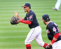 two baseball players are on the field during a game, one is holding his mitt