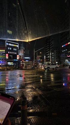 a city street at night with cars and buildings