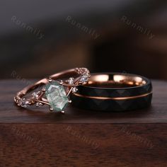 two wedding rings sitting on top of a wooden table next to each other with diamond accents