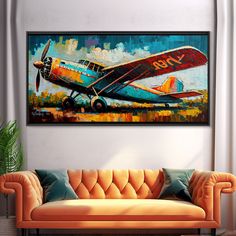 an airplane painted on the wall above a couch in a living room with orange furniture