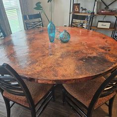 a round table with four chairs around it