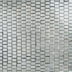 a close up view of a glass mosaic tile wall