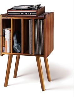 an old record player is sitting on top of a wooden stand with vinyl records in it