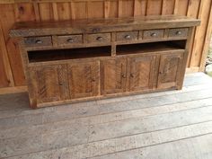 a large wooden cabinet with drawers on top