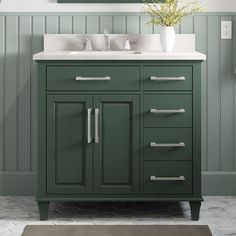 a bathroom vanity with two sinks and a mirror on the wall above it, along with a rug