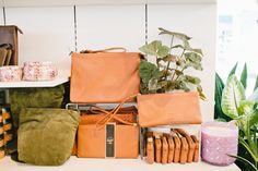 a table topped with lots of different types of purses and other items on top of it