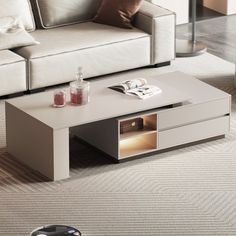 a living room with a couch, coffee table and remote control on the carpeted floor