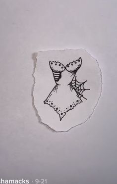 a piece of paper with a drawing of a woman's dress and spider webs on it