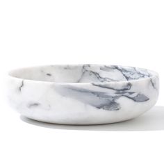 a white marble bowl sitting on top of a table