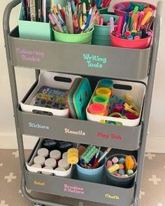 a cart with lots of crafting supplies on it and writing tools in the bins