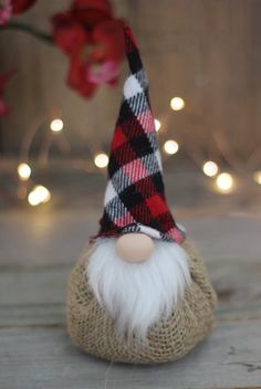 a red and black plaid gnome hat on top of a burlock