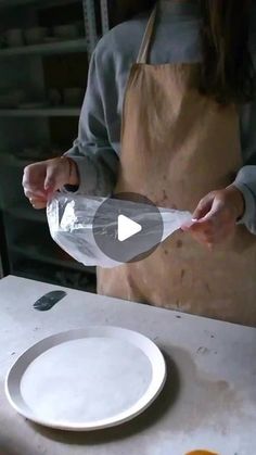 a person pouring something into a bowl on top of a table