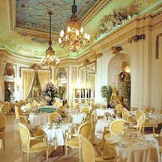 a fancy dining room with chandeliers and tables